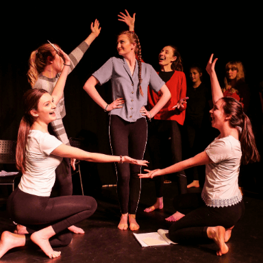 A group of young people performing on stage.