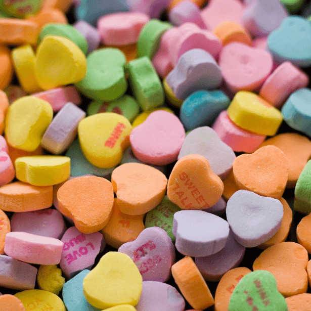 A close up of small heart shaped sweets.